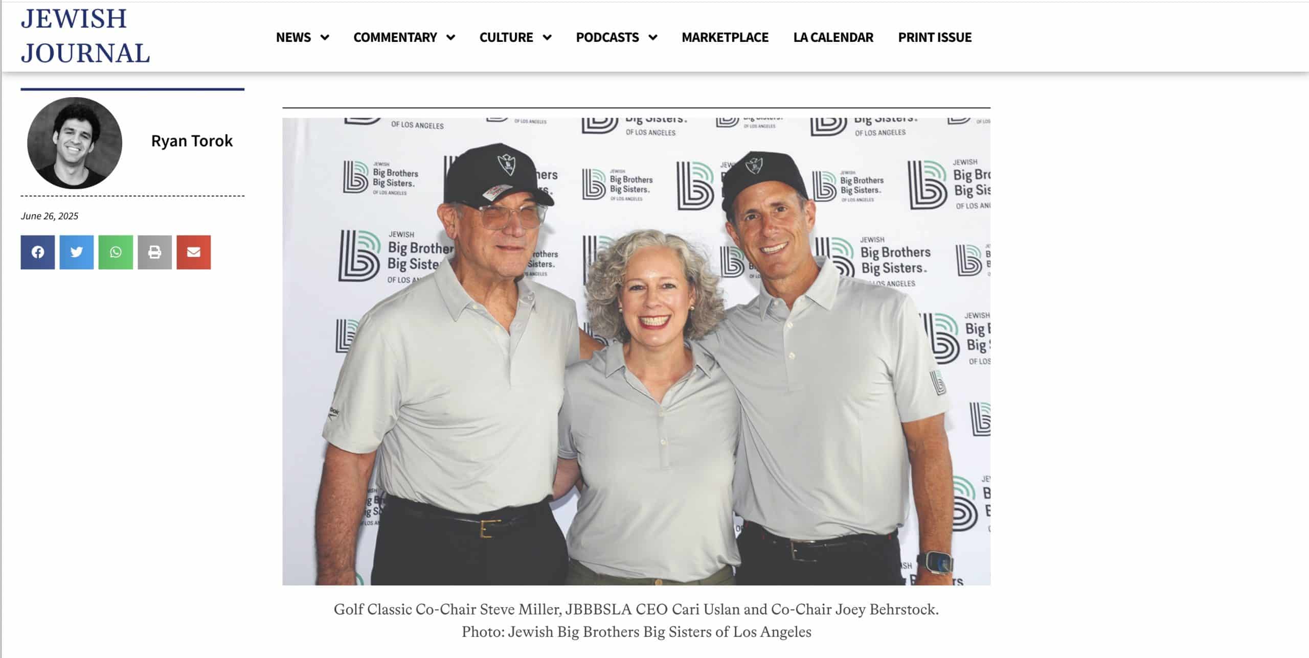 Three adults in matching light gray polo shirts and black caps stand together smiling in front of a step-and-repeat banner for Big Brothers Big Sisters of Los Angeles.